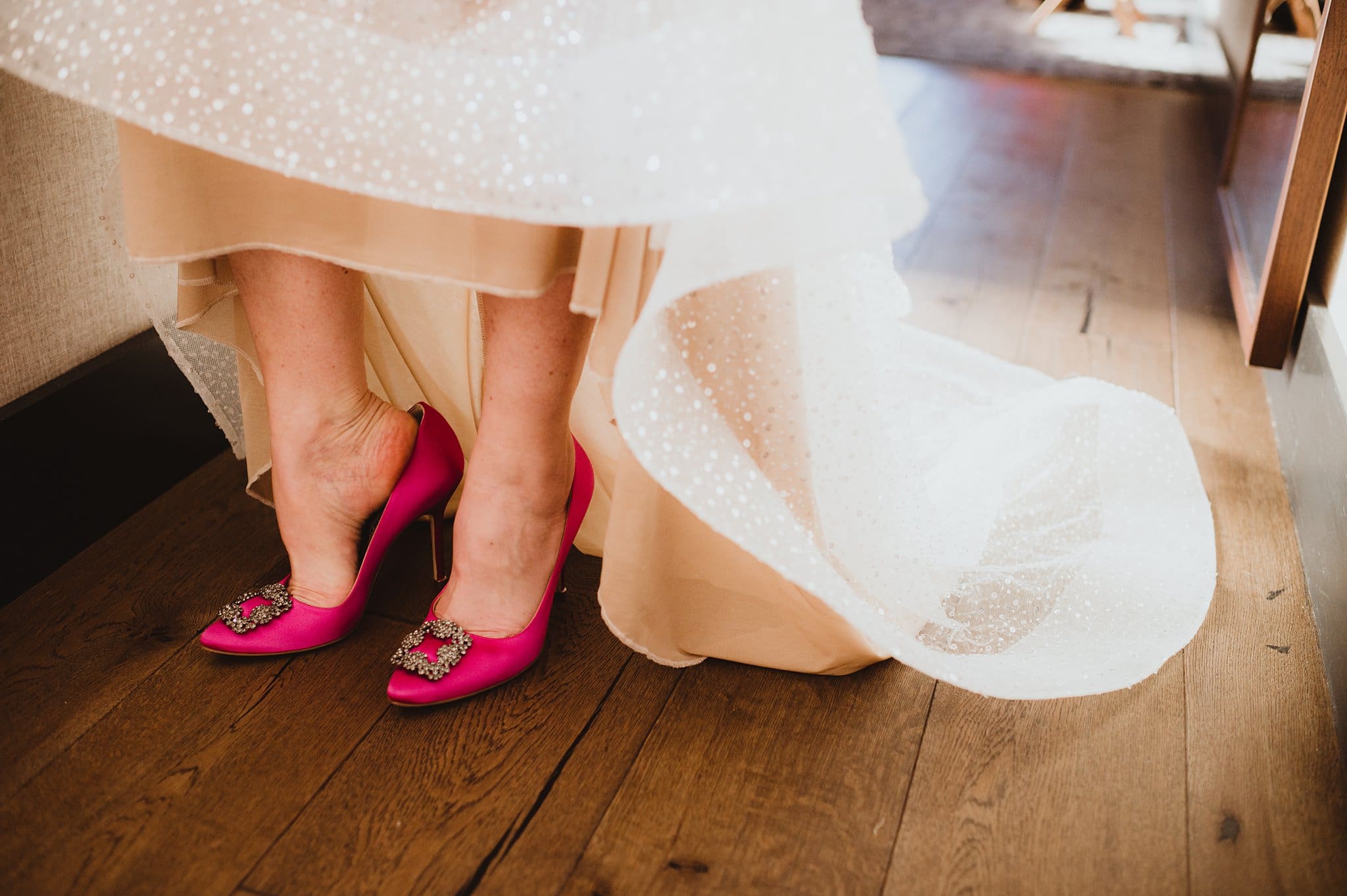 bride putting on hot pink heels