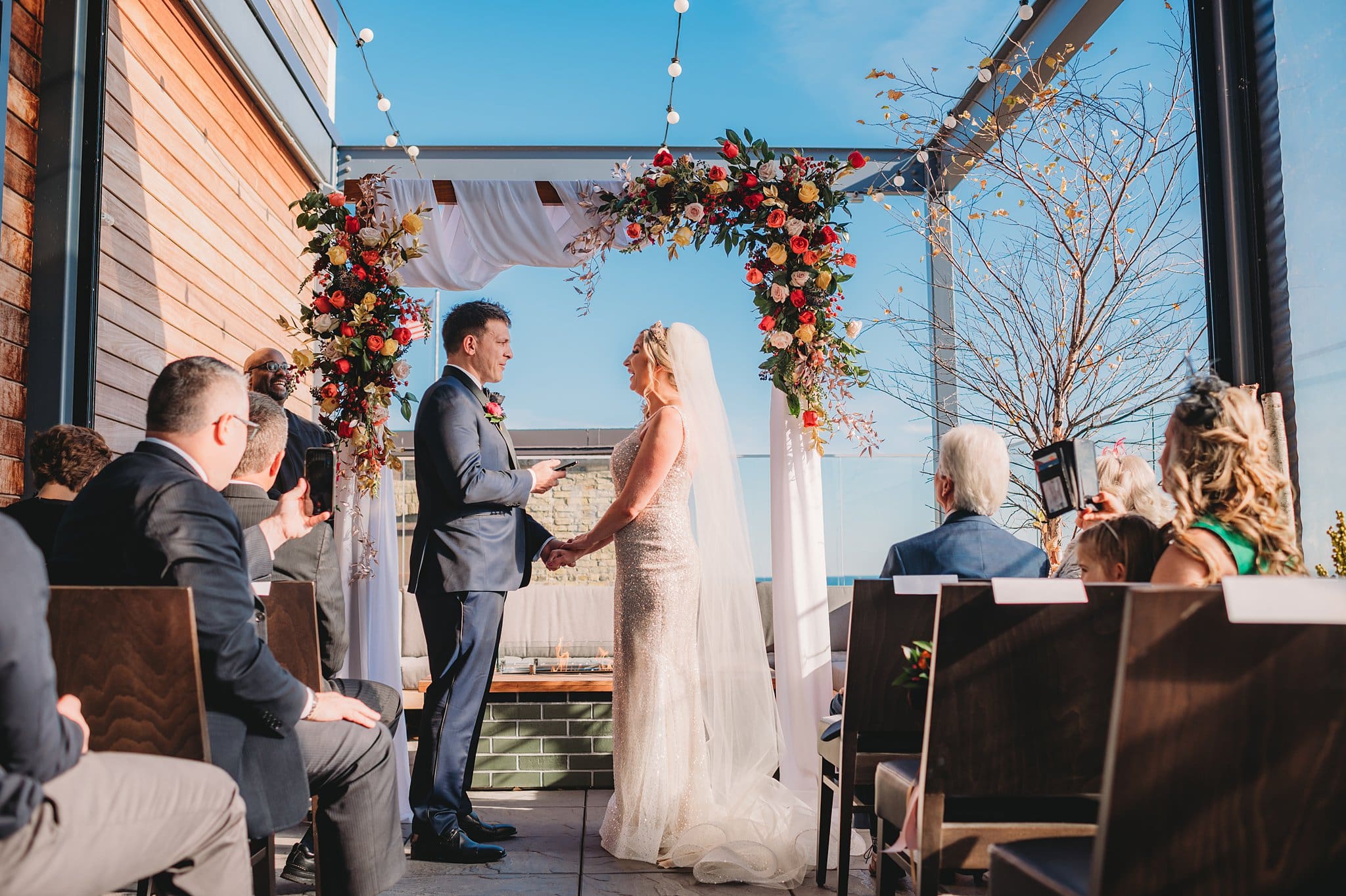 wedding ceremony on patio balcony at journeyman hotel wedding photographer milwaukee