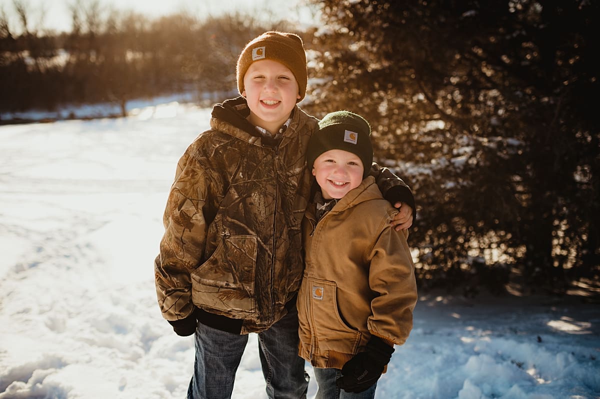 two brothers hugging in the snow for lake geneva family photography session