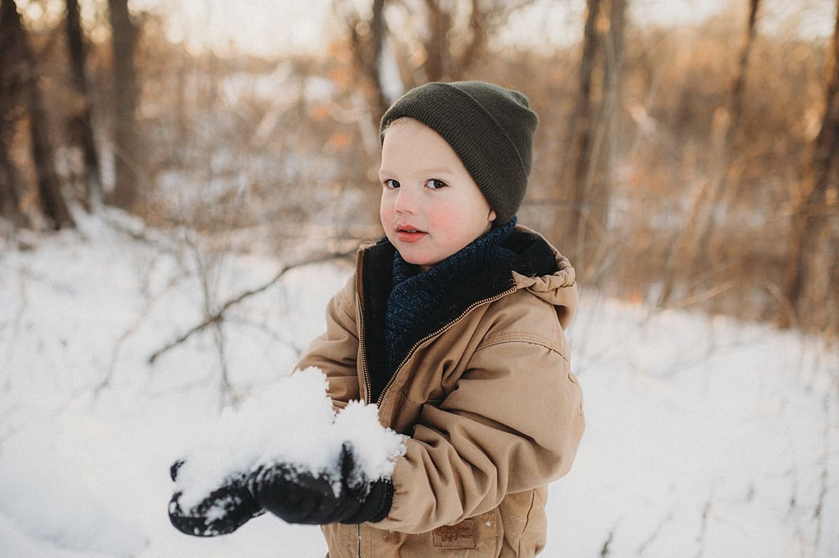 kids holding snow while staying warm what to wear during an outdoor photography