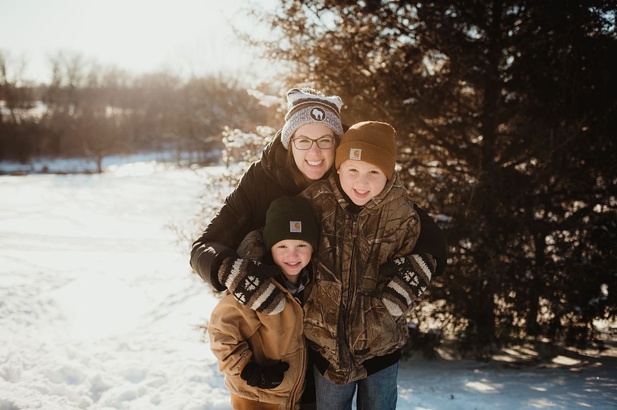 mom with boys during snowy family session