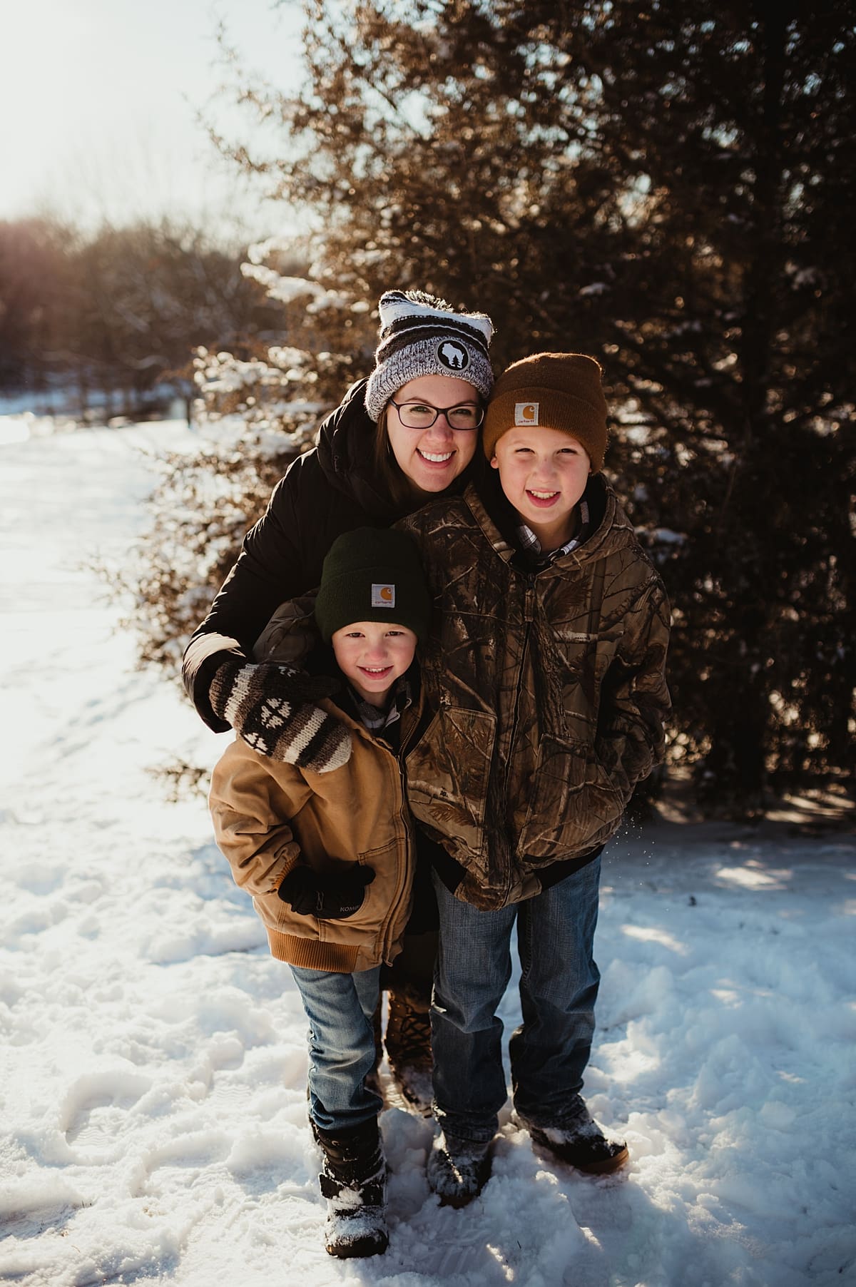 mom with boys during snowy family session