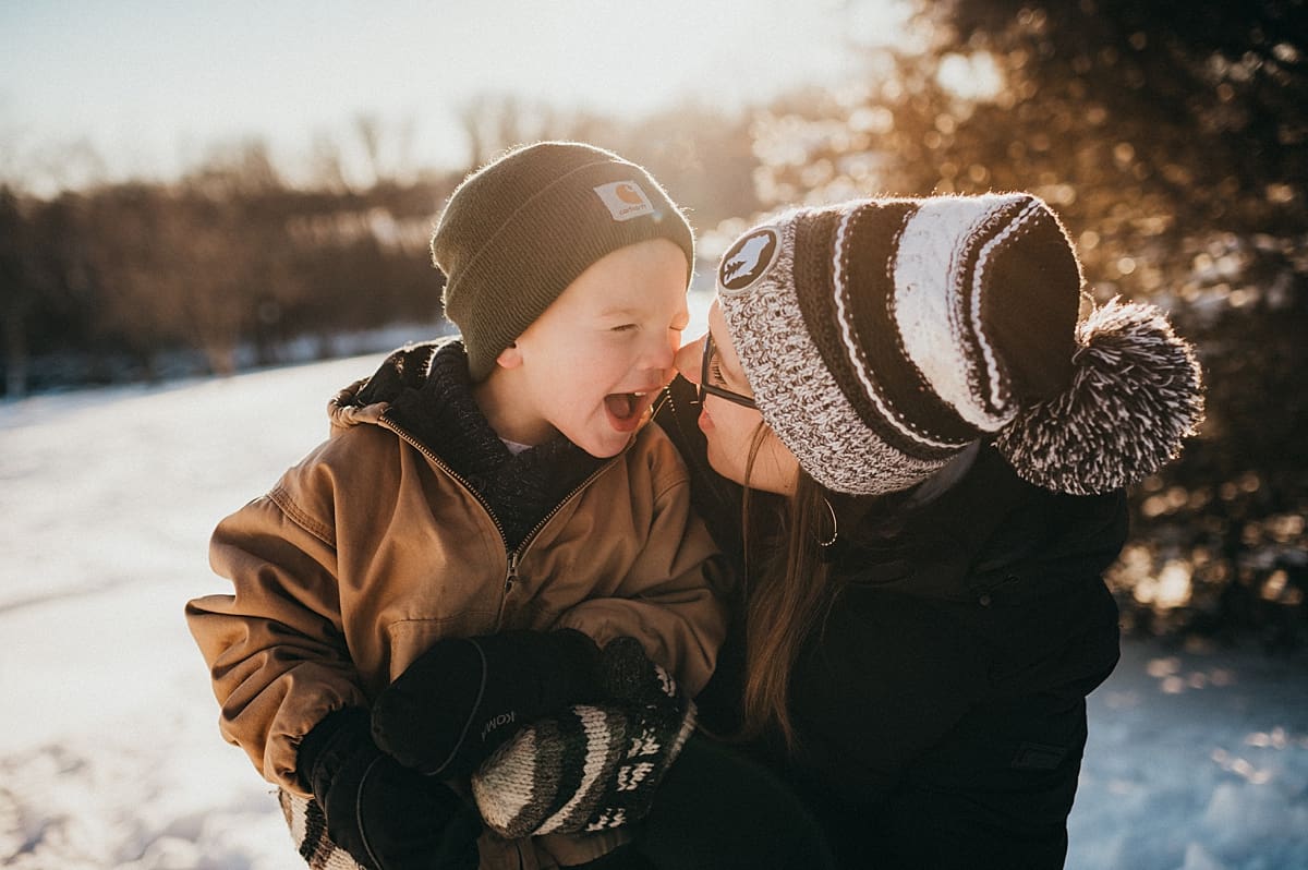 tickles during snowy family photo session