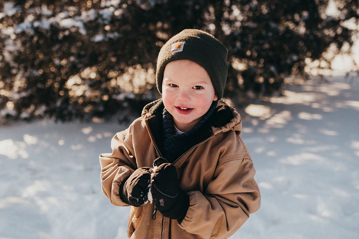 little brother during snowy family photo session