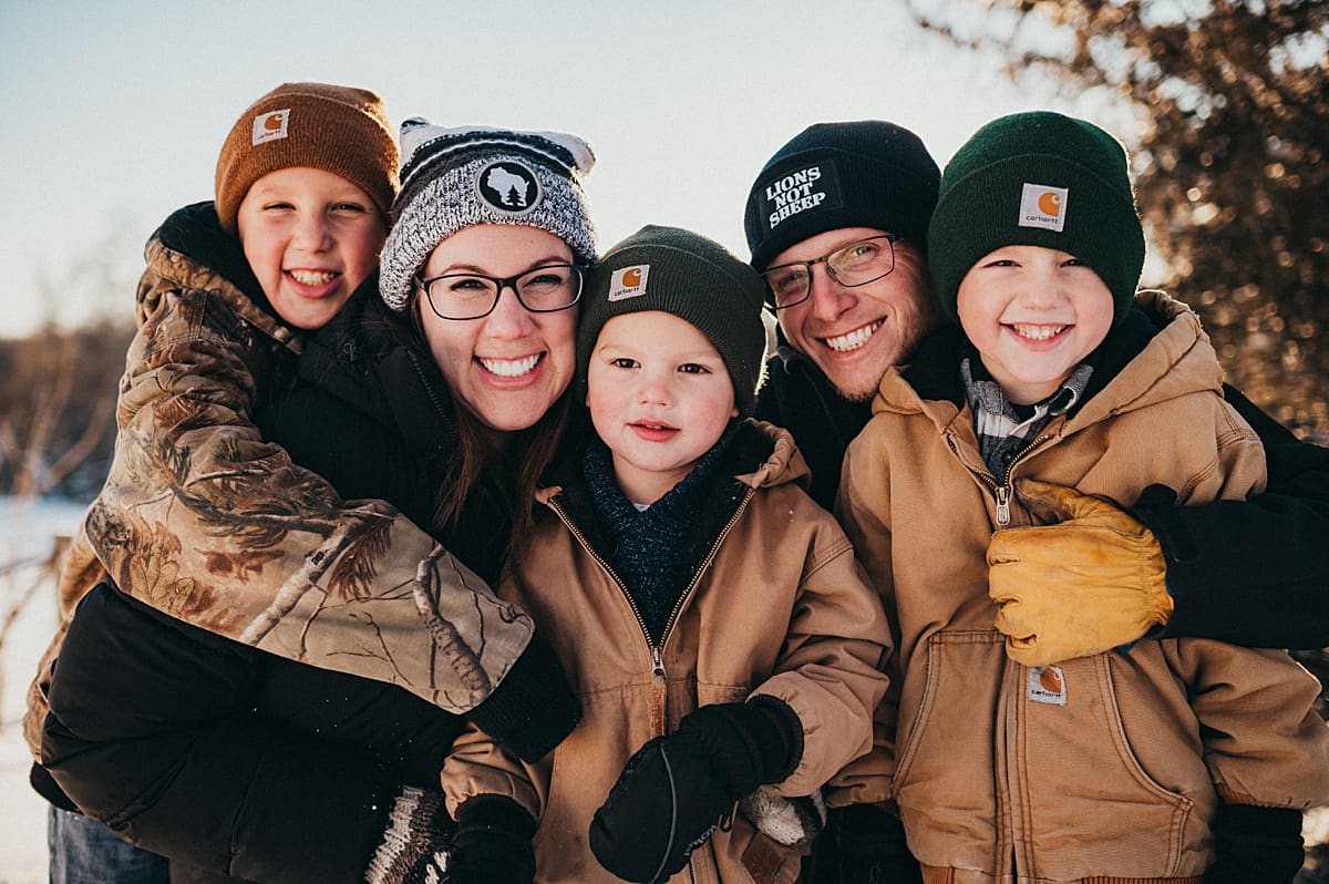 staying warm during snowy wintery family photo in Lake Geneva