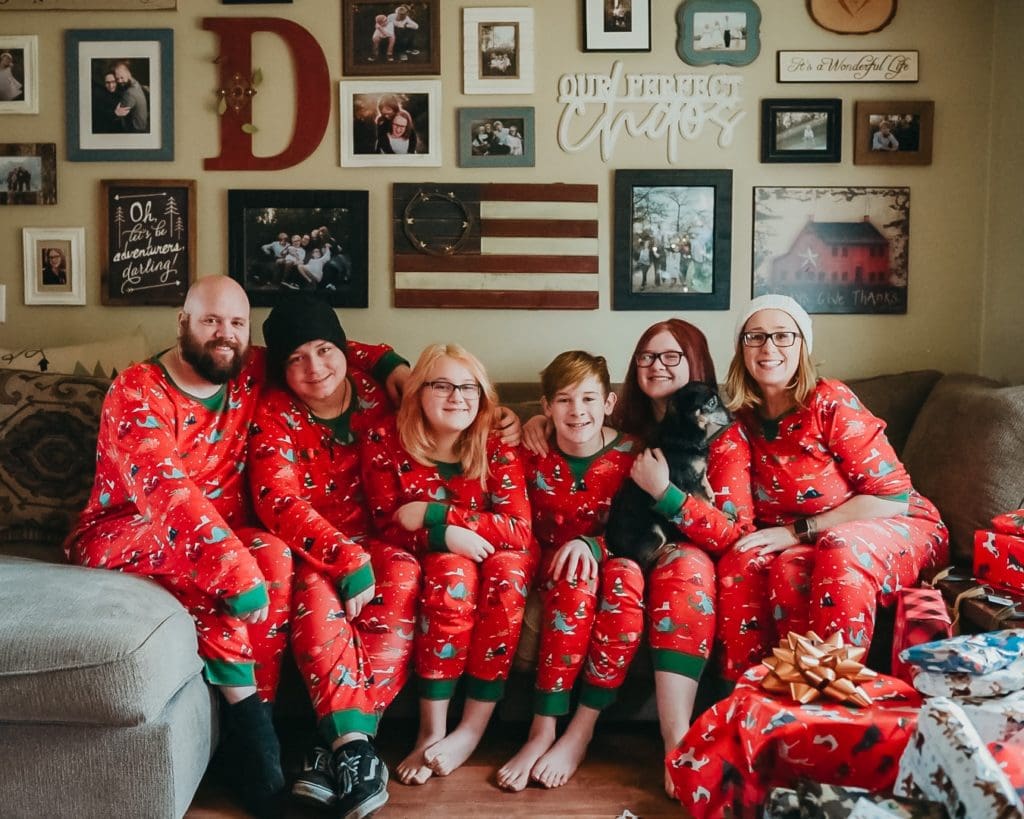 Large family with teenagers in matching Christmas pajamas