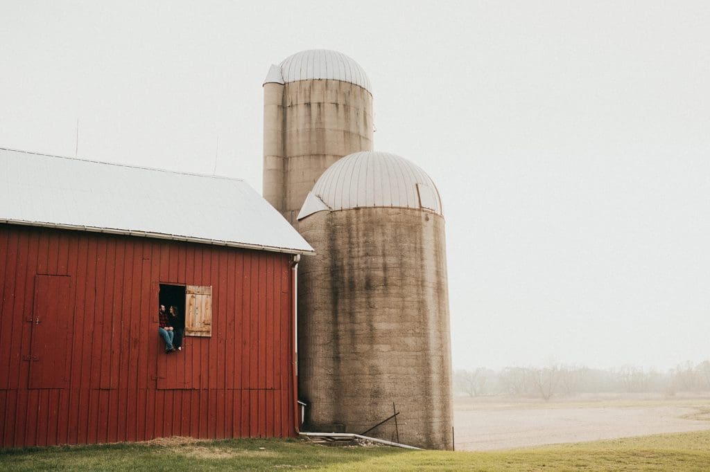 engagement photos with old red barn and silos