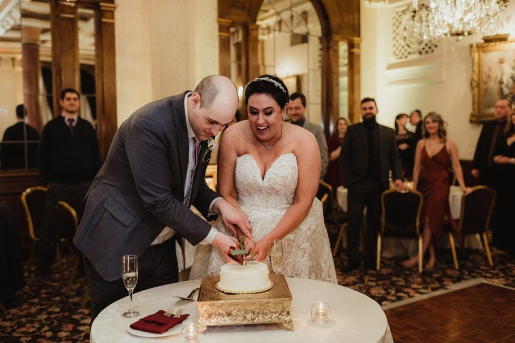 wedding couple cutting their small wedding cake