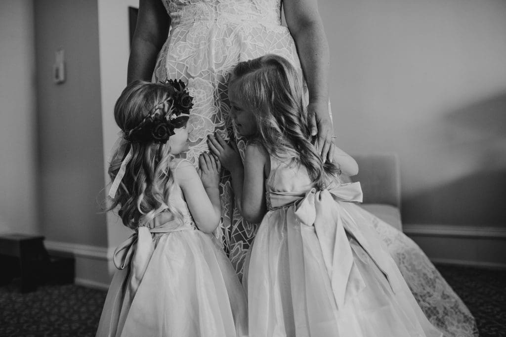 flower girls hugging the bride