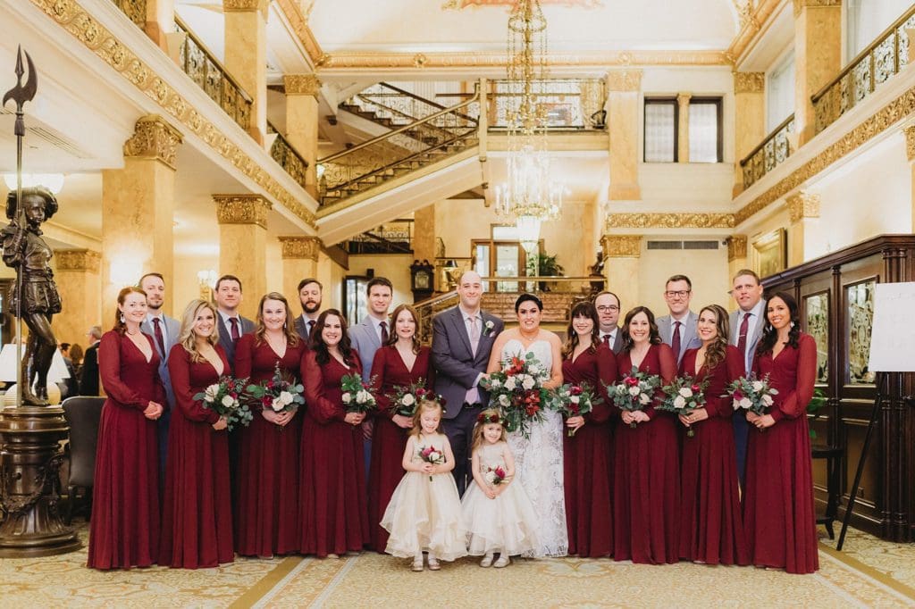 large wedding party in the lobby of the pfister hotel in milwaukee