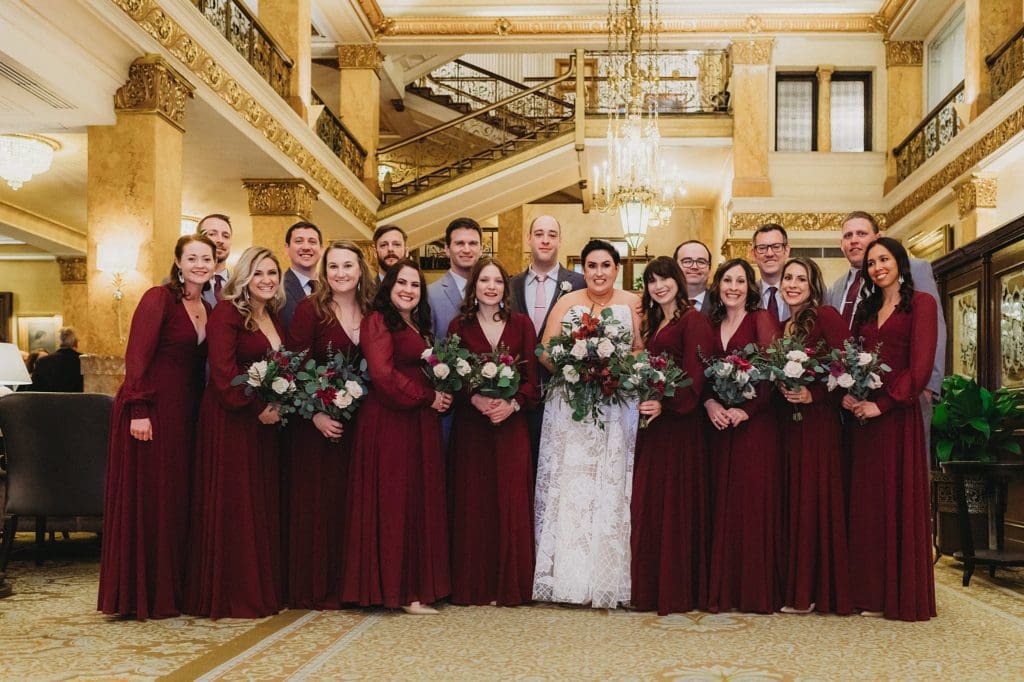 large wedding party in the lobby of the pfister hotel in milwaukee