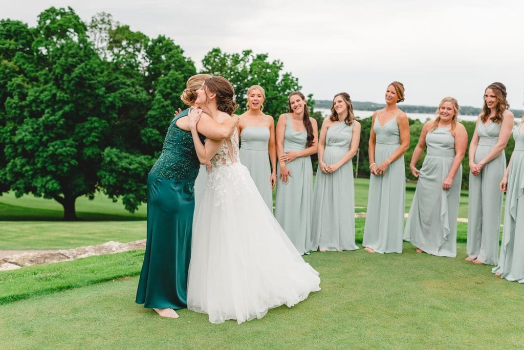 bride getting ready with bridesmaids outside on the golf course