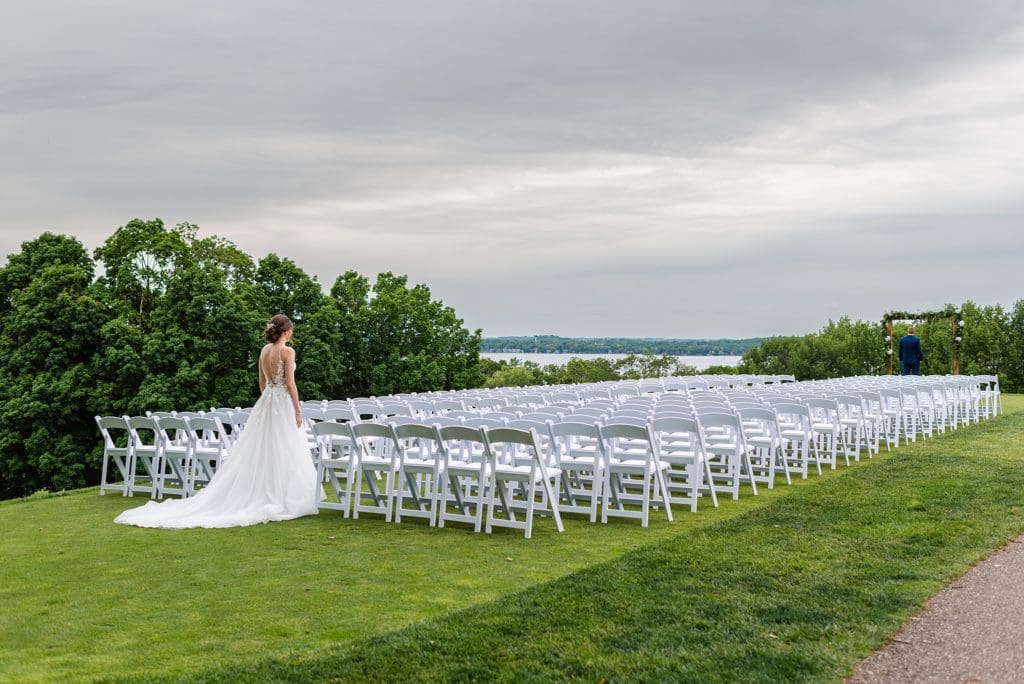 first look at outdoor wedding ceremony on a golfing green