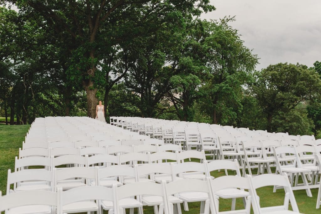 first look at outdoor wedding ceremony on a golfing green