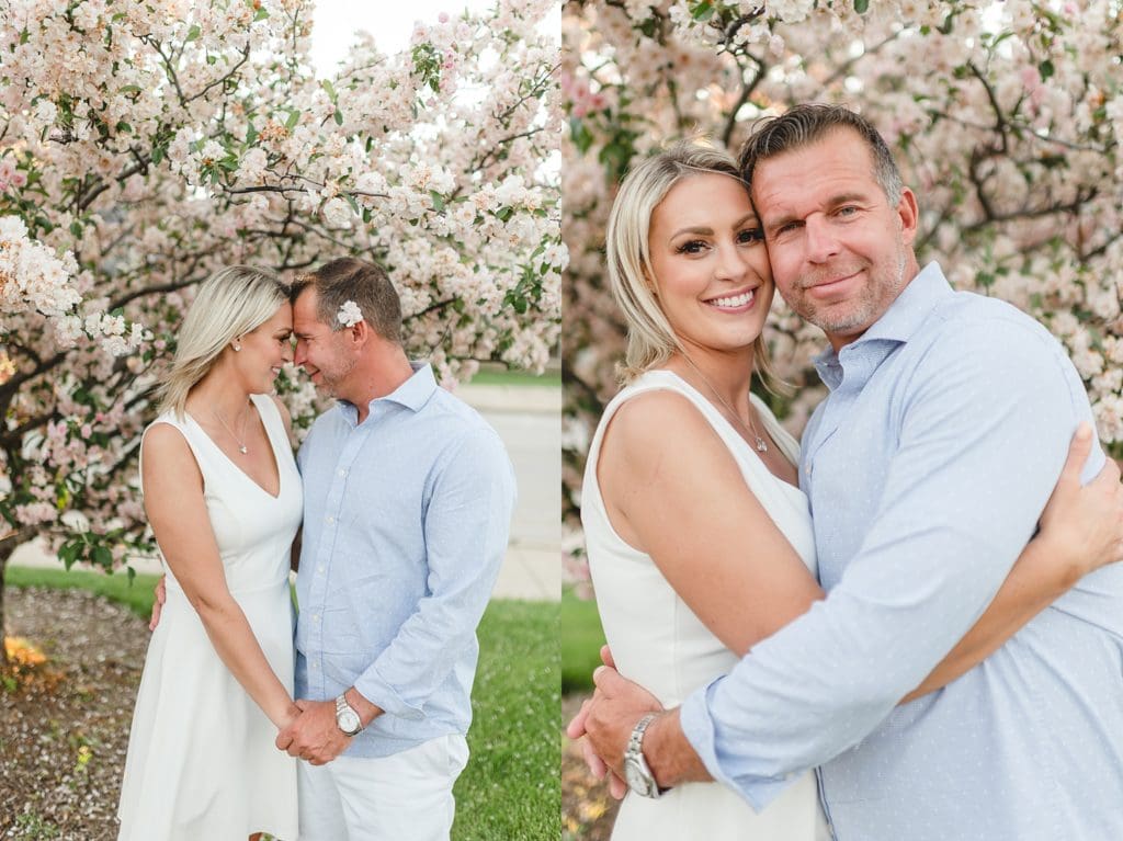 engagement photos in front of pink flowering fruit tree