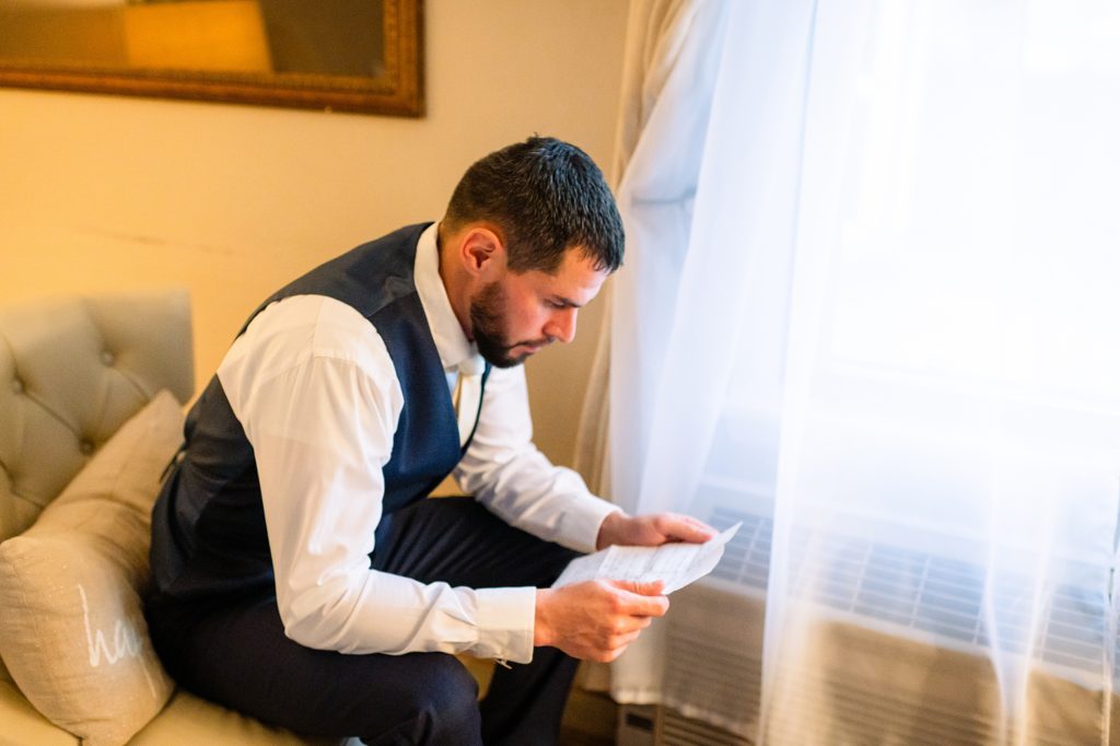 groom reading vows before wedding