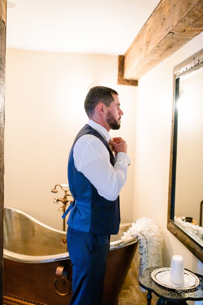 groom getting ready in front of the mirror