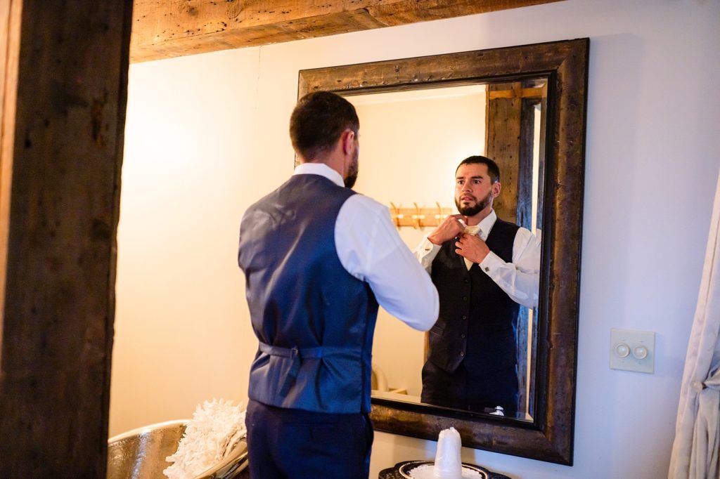 groom getting ready in front of the mirror