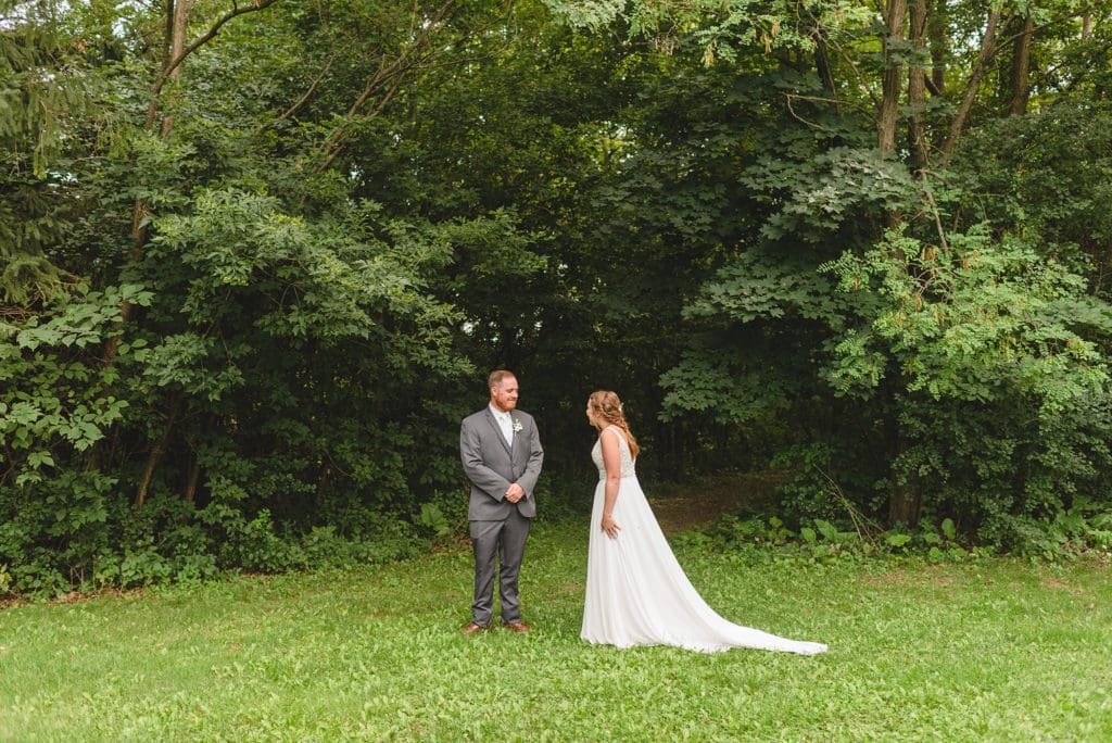 outdoor wedding first look in front of the forest
