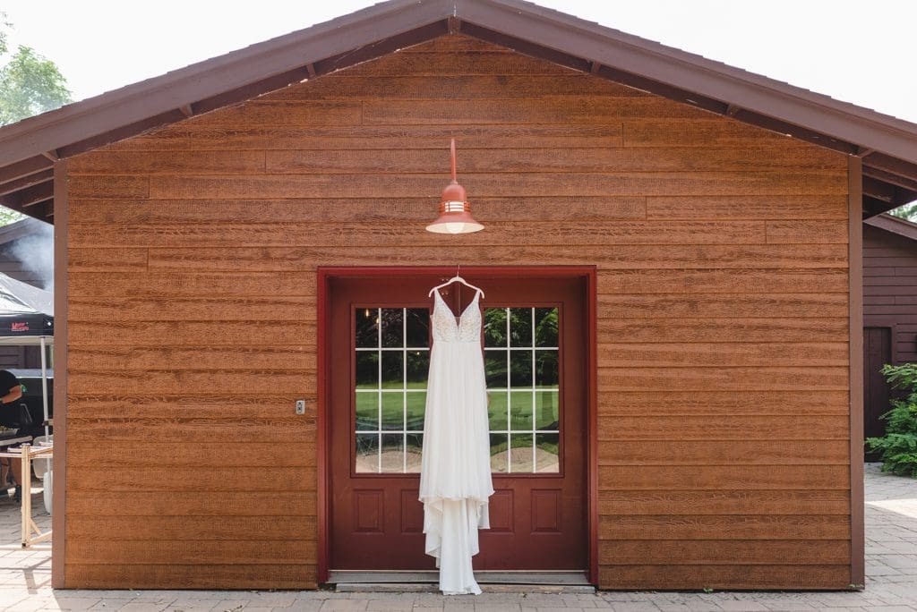 wedding dress hanging up outside cabin