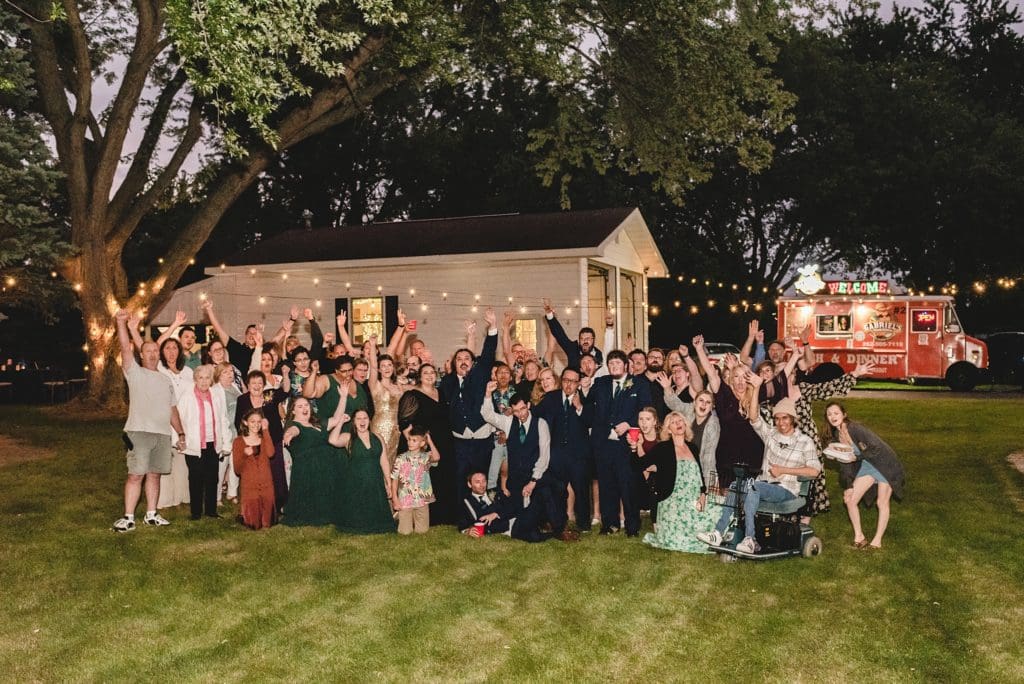 large family photo at backyard reception