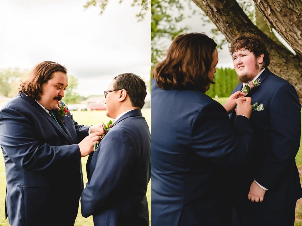 groom and groomsmen putting on boutonnieres 