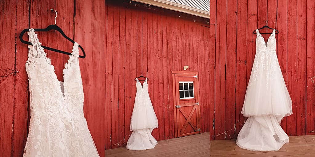 dress hanging up on the side of a red barn