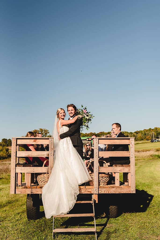 bride and groom on a hay ride