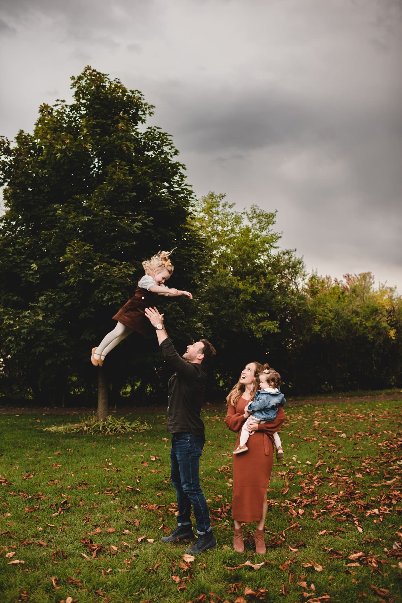 dad tossing 3 year old daughter in the air