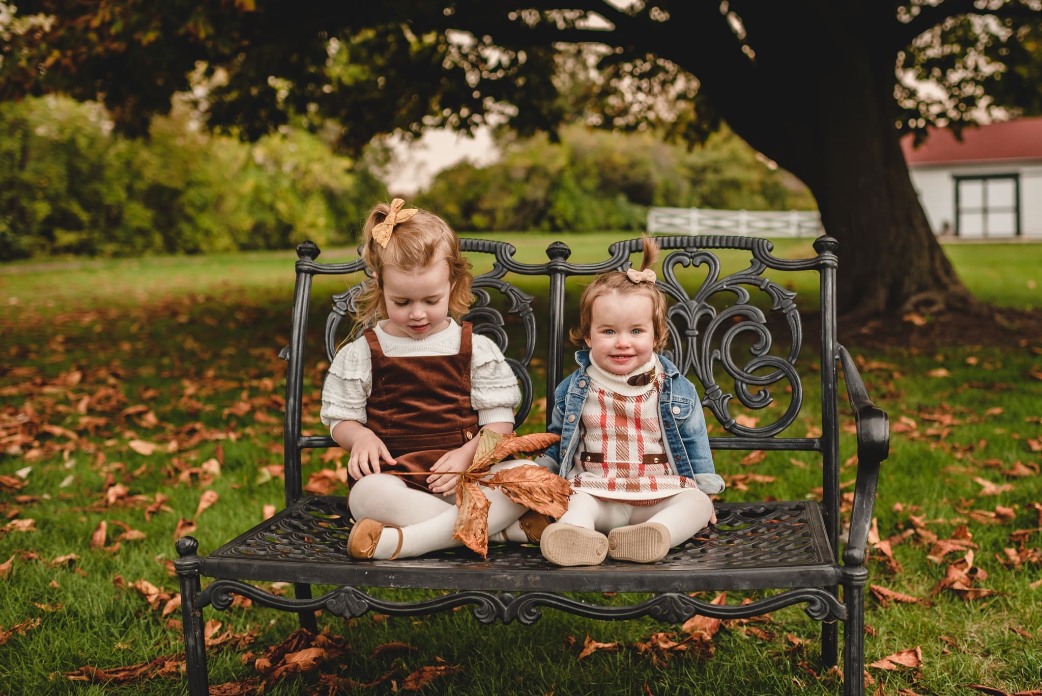 two sisters sitting on a bench together