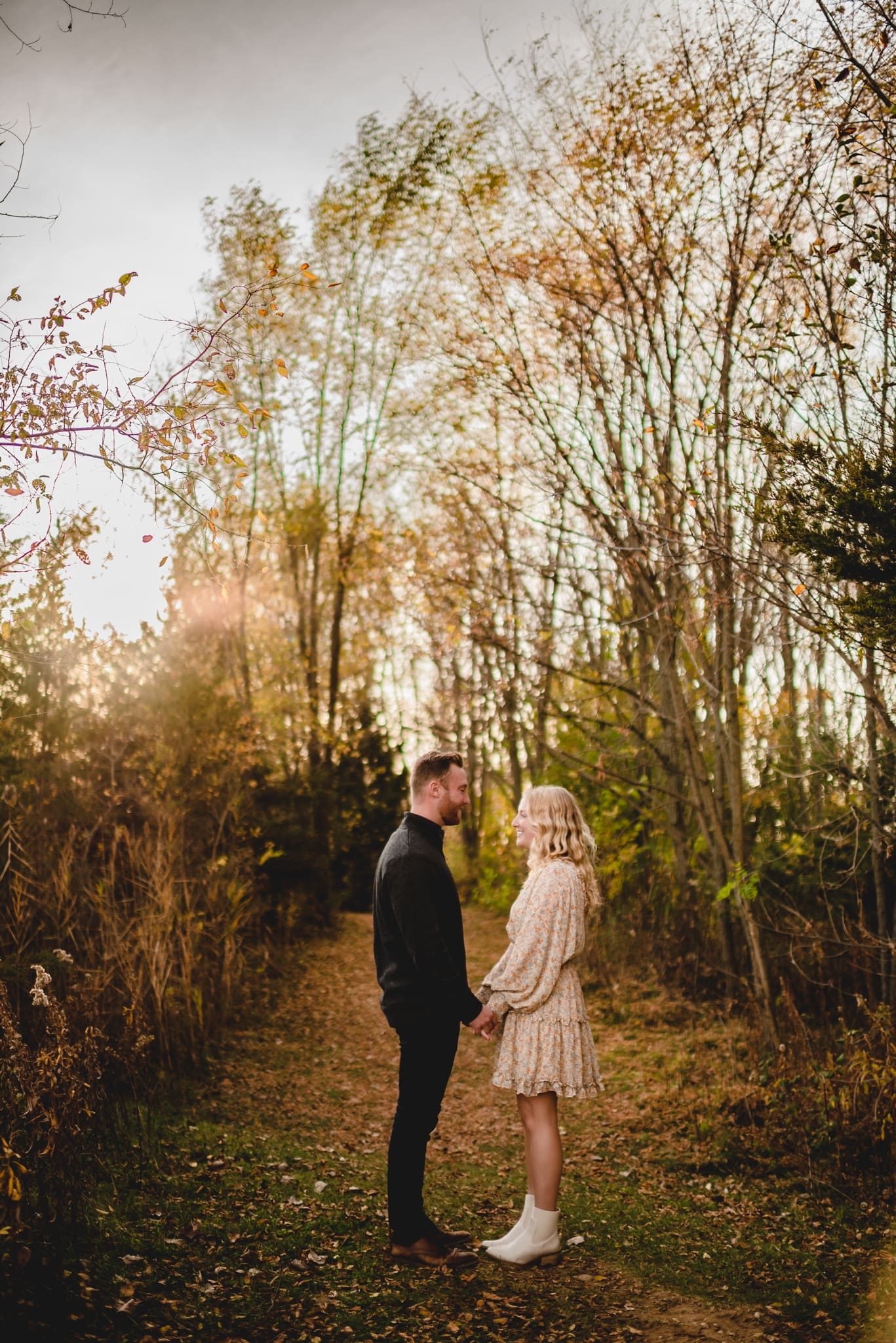 couple in the forest on a trail for engagement photos