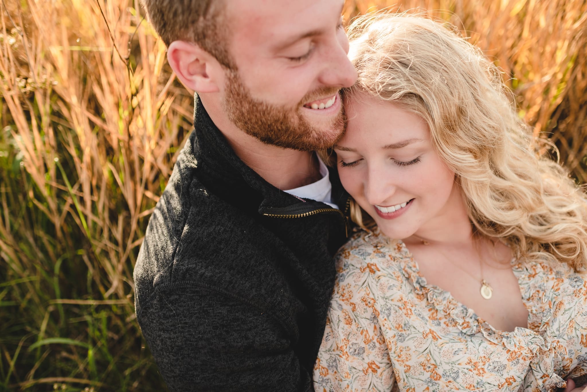 woman snuggling into fiance's chest laying down pose