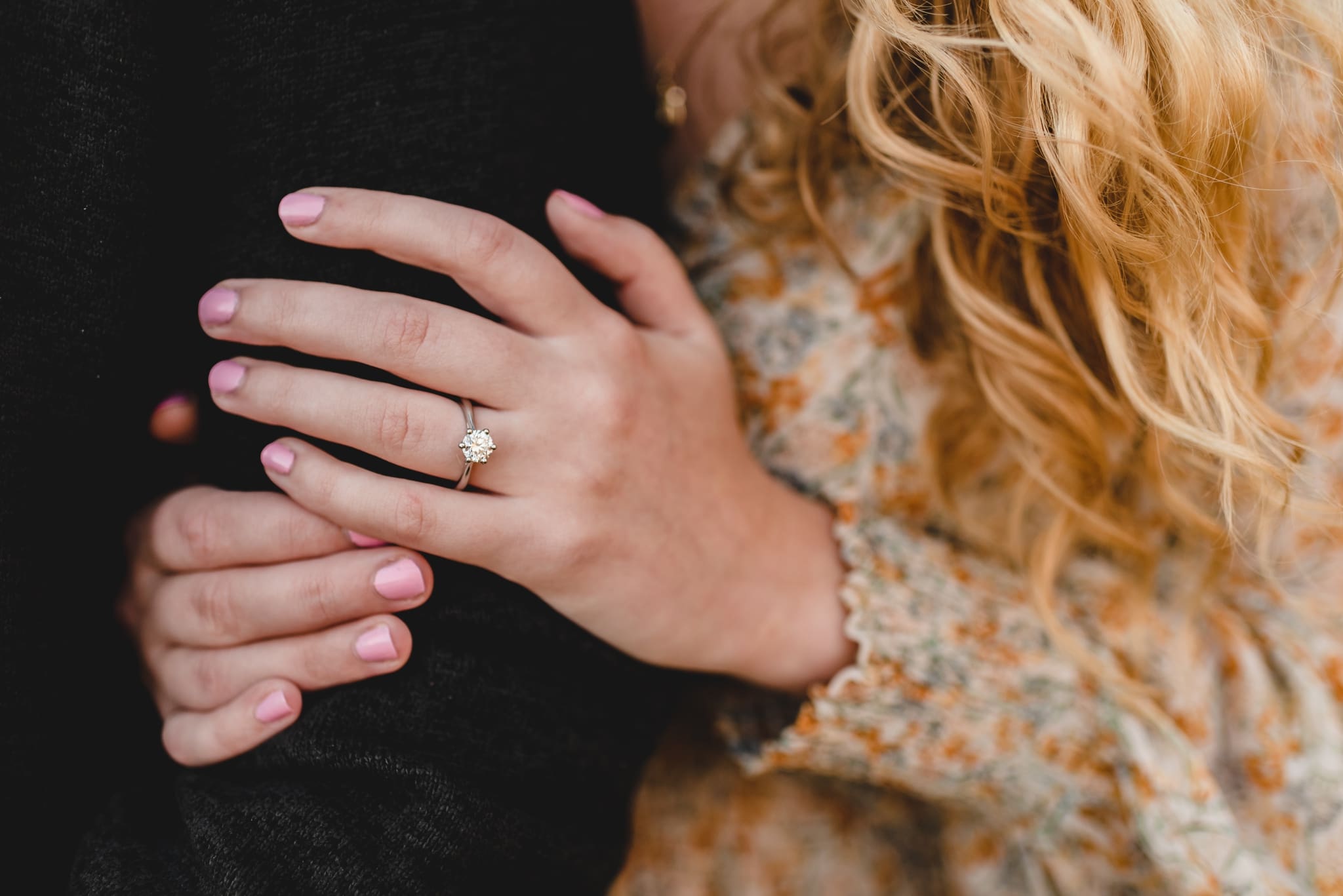 close up of engagement ring during engagement photos