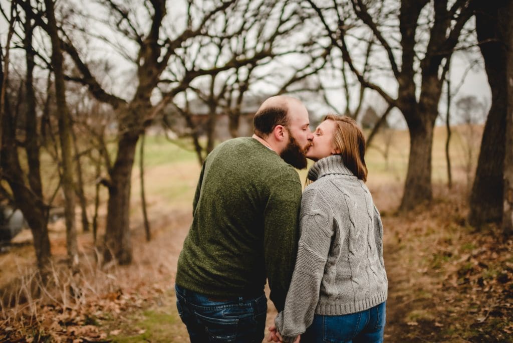 couple walking together and kissing from behind photography pose 