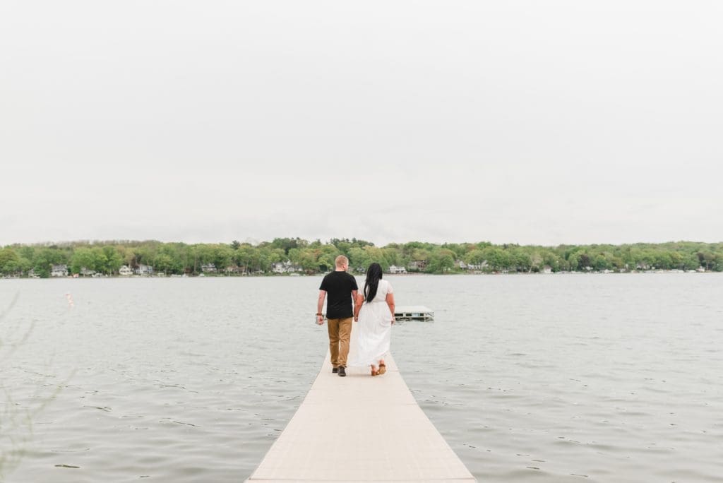 engagement photos on a lake pier