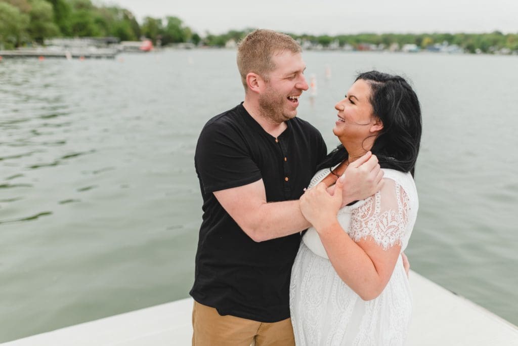 engagement photos on a lake pier