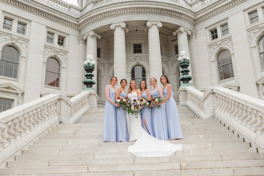 bridal party photos on the steps of the wisconsin capitol building