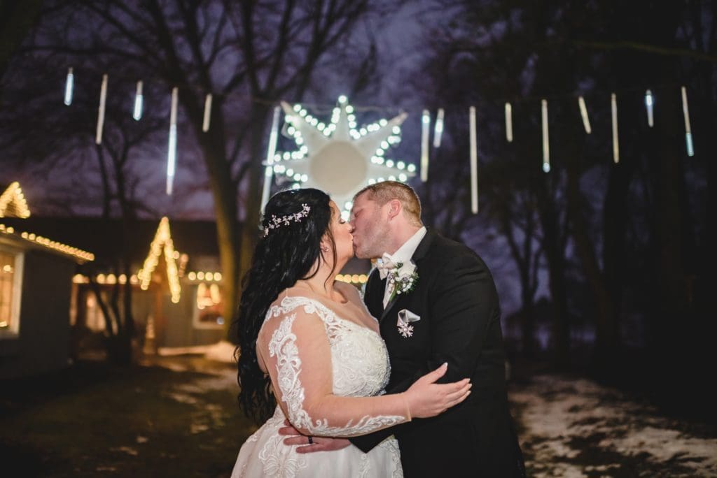 winter wedding photos at night with christmas lights and decor