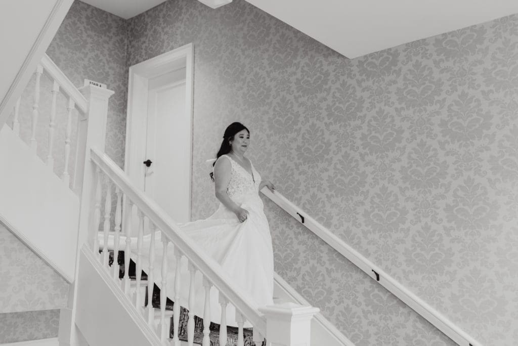 wedding first look at the stella hotel in kenosha on the staircase