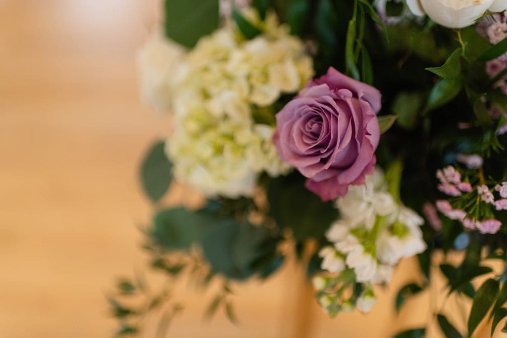 purple and white wedding flowers with greenery