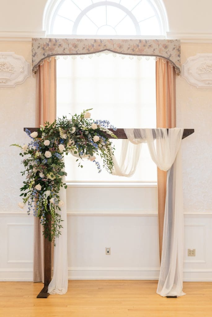 wedding arch with flowers and swag