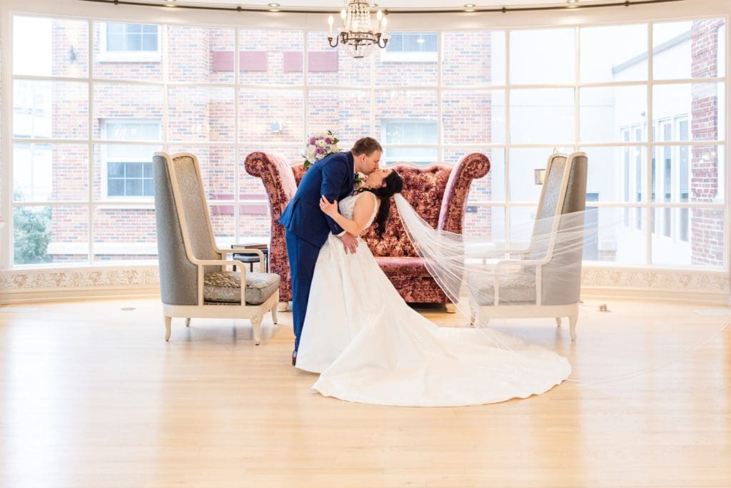 bride and groom in the lobby at the stella hotel in kenosha wedding photos
