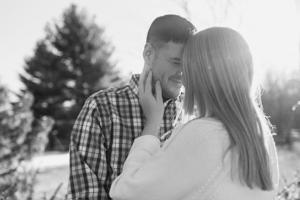 woman holding man's face engagement photo pose
