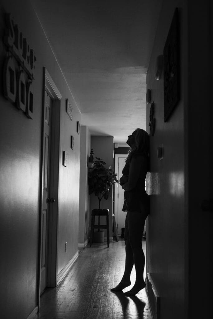 black and white silhouette of boudoir woman in hallway