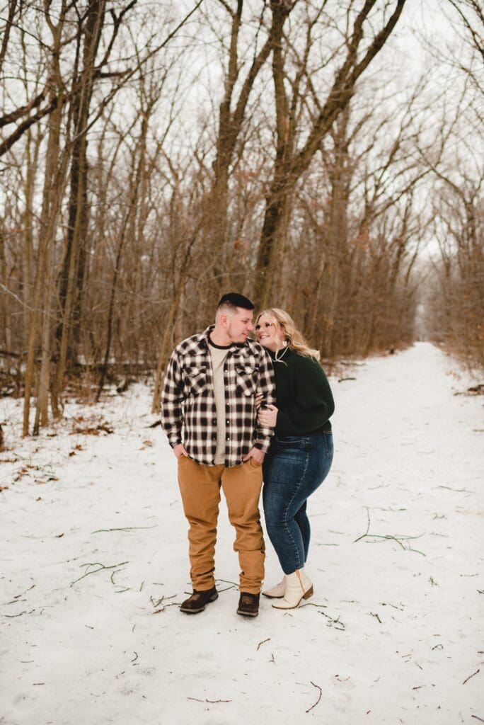 winter engagement photo of couple looking at each other