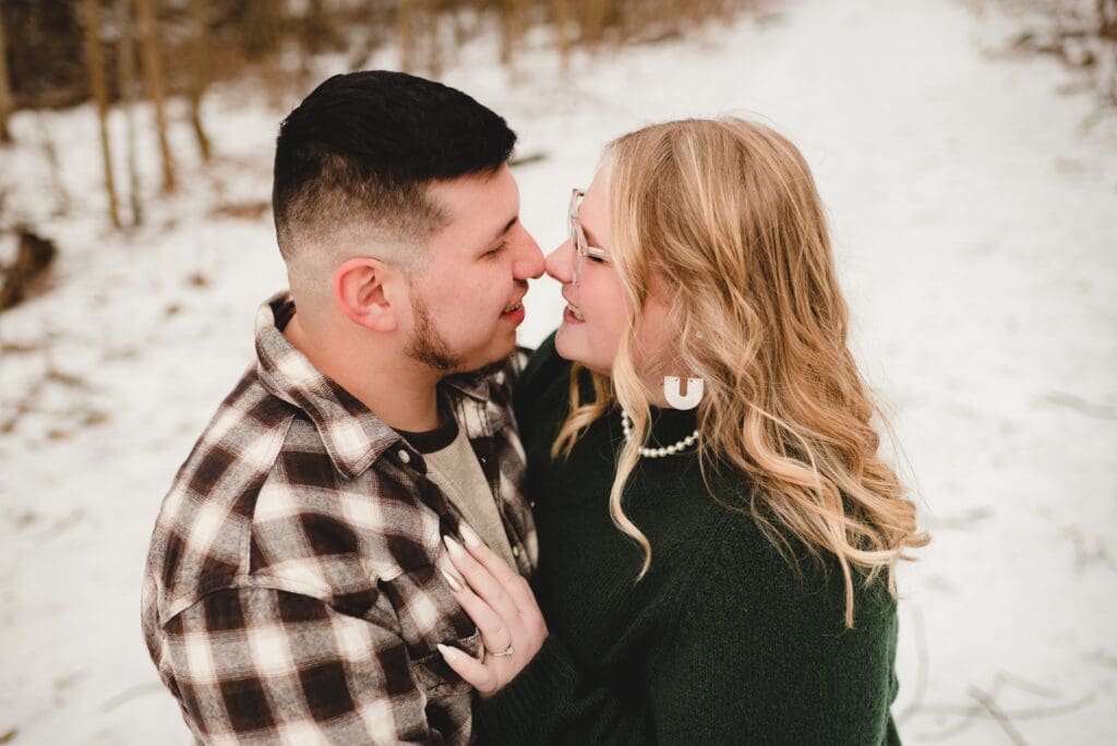 engagement photo of couple looking at each other and rubbing noses