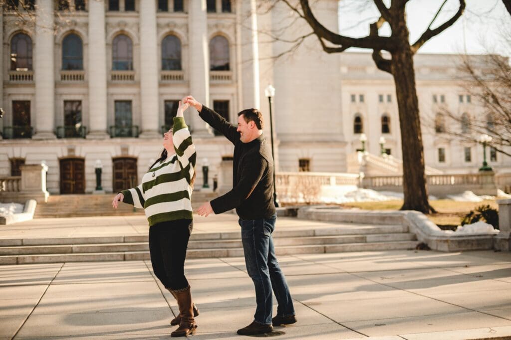 couple dancing together in front of the wisconsin capitol building