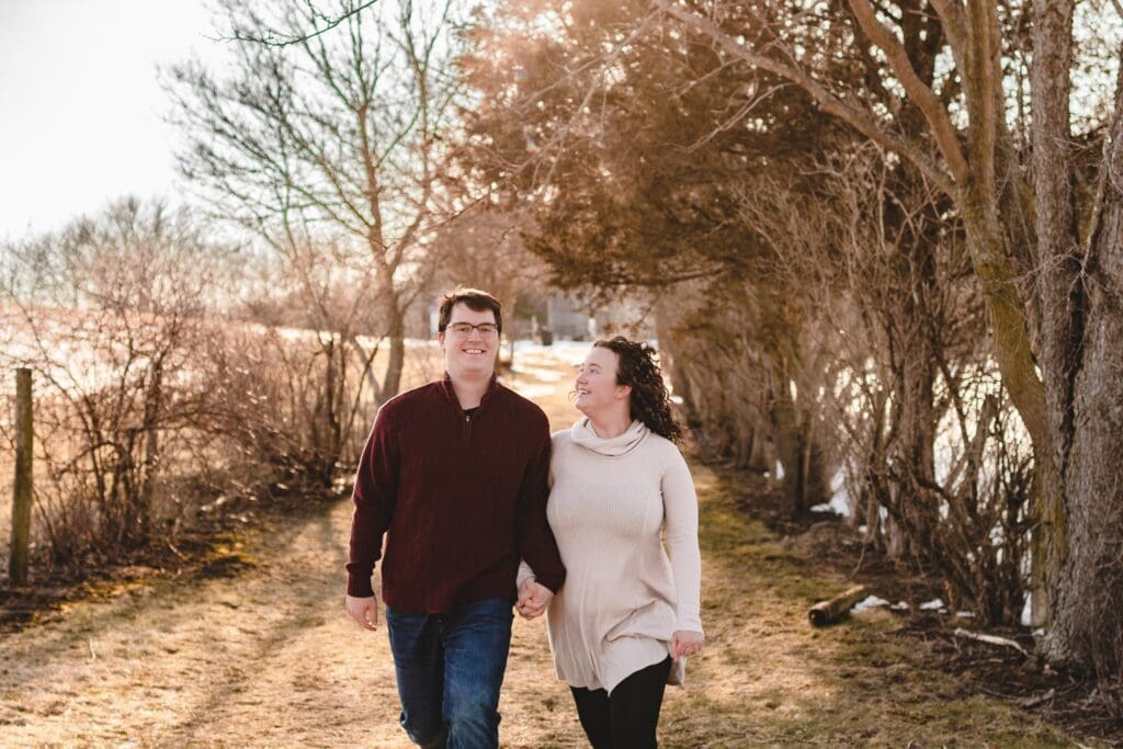 couple walking together in late winter engagement photos