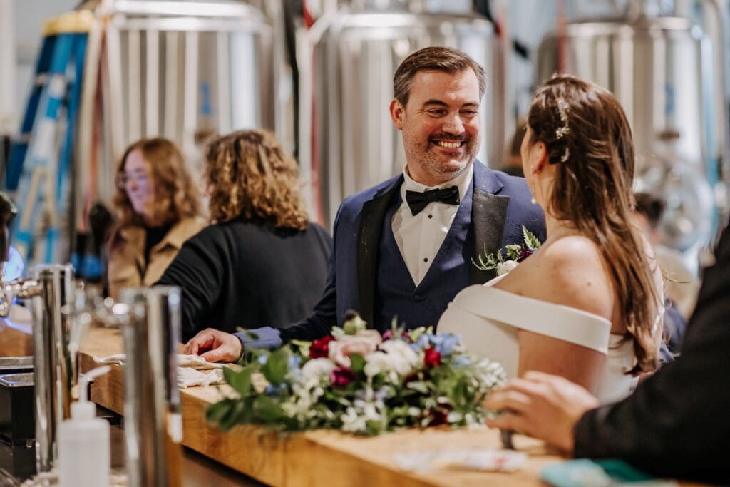 bride and groom go to a brewery for a beer