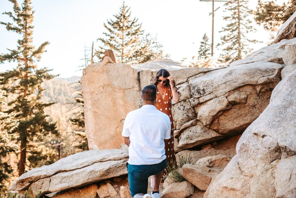 man proposing at the top of the palm springs mountains